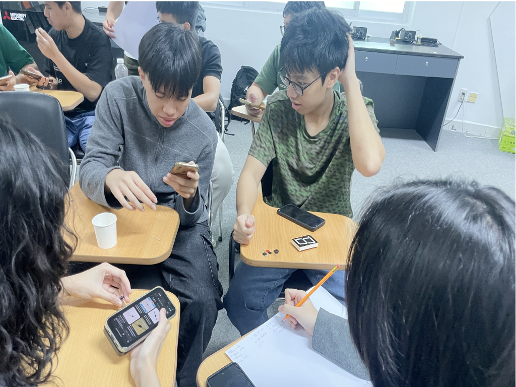 Students trying the wearable prototype together.
