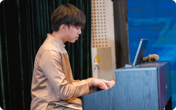 Khoi playing the keyboard on stage