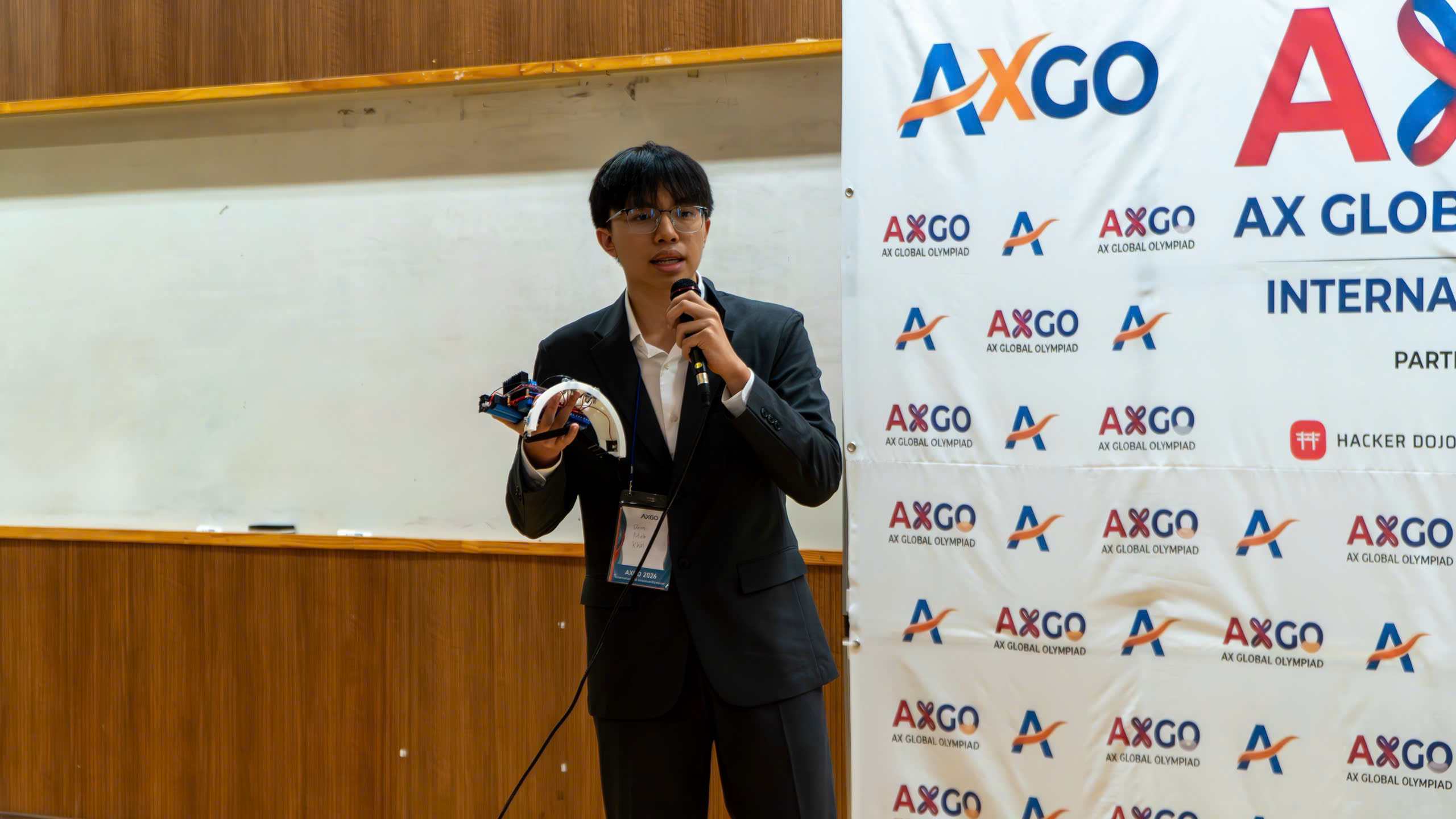 Khoi presenting his assistive mobility device at the AX Global Olympiad